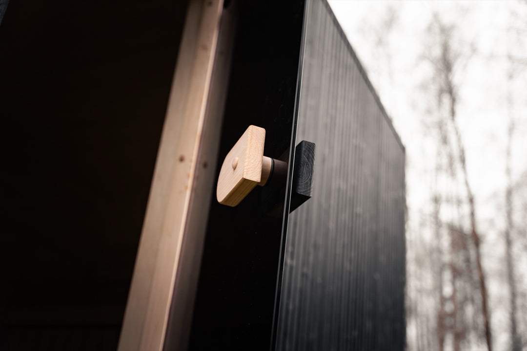 VALO L garden sauna detail – wooden door handle against black board cladding